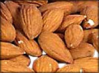 Photo of a pile of almonds with skin.