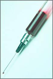 High cholesterol symptoms: Taking a blood test: A needle with blood, a blood sample.