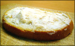 Avoiding symptoms of high cholesterol: Picture of a piece of bread with lard.